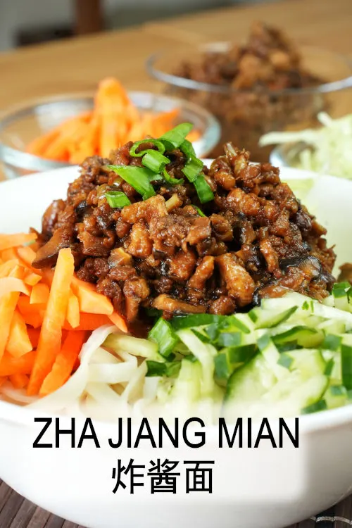 Zha Jiang Mian (Beijing fried sauce noodles, 炸酱面) is prepared with made a meat sauce comprised of soybean paste 黄豆酱 and sweet bean paste 甜面酱, coupled with crunchy vegetables.