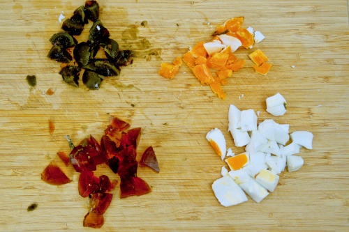 Cut the salted egg and century into small pieces, white and yolk separated