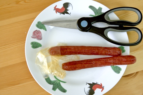 Blanch the sausage in boiling water for thirty seconds to loosen the casing