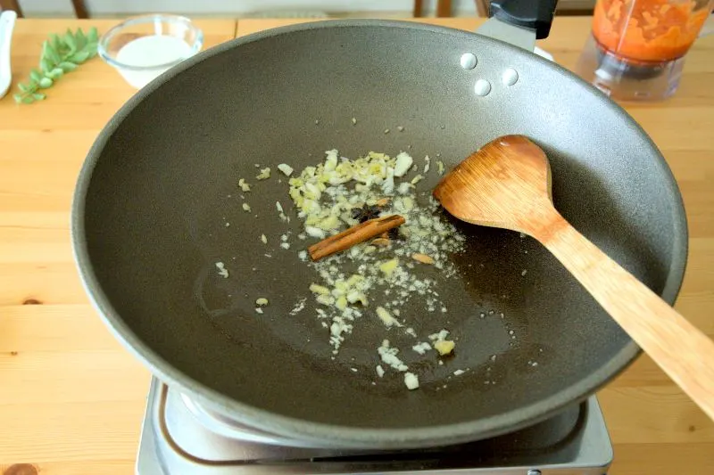 Throw in the cinnamon bark, star anise, cardamom, and cloves.