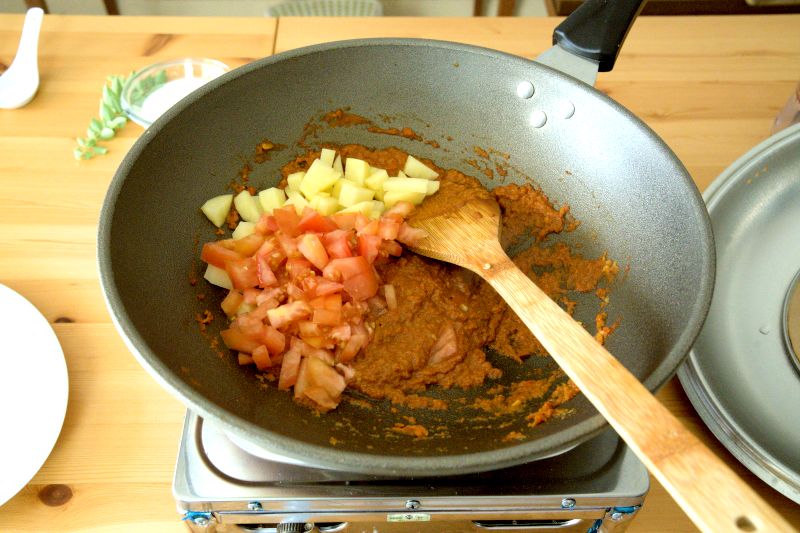 include the potatoes, tomatoes, and a cup of water to cook