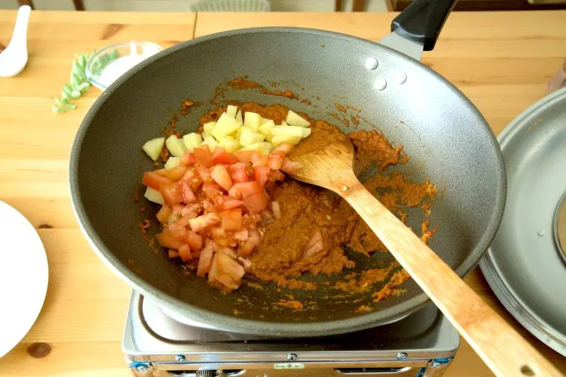 include the potatoes, tomatoes, and a cup of water to cook