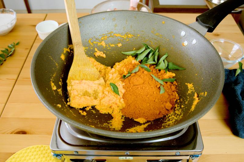 Add the curry leaves and curry powder. 
