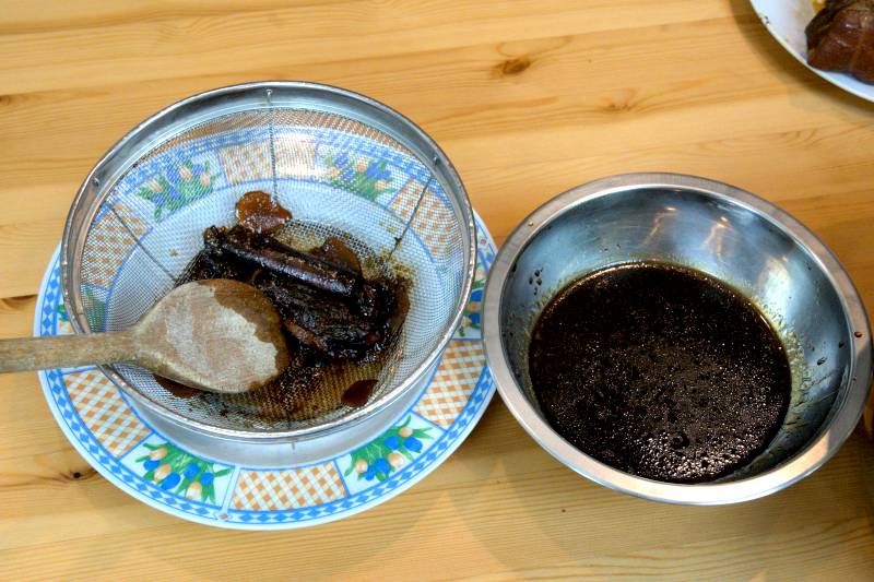 Strain the gravy through a fine wire mesh strainer for a smooth, clean sauce. (braised pork belly)