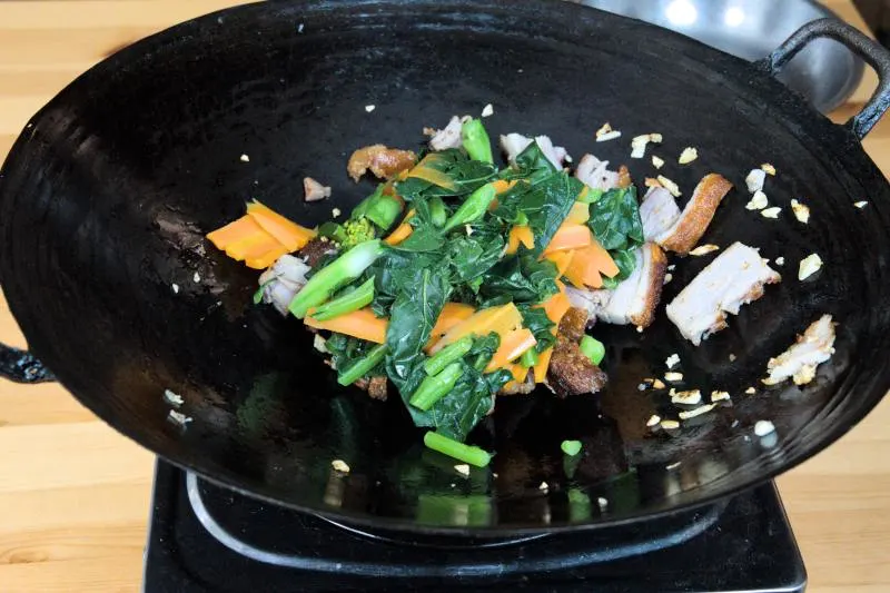 stir fry the roast pork with gai  lan and the chopped garlic