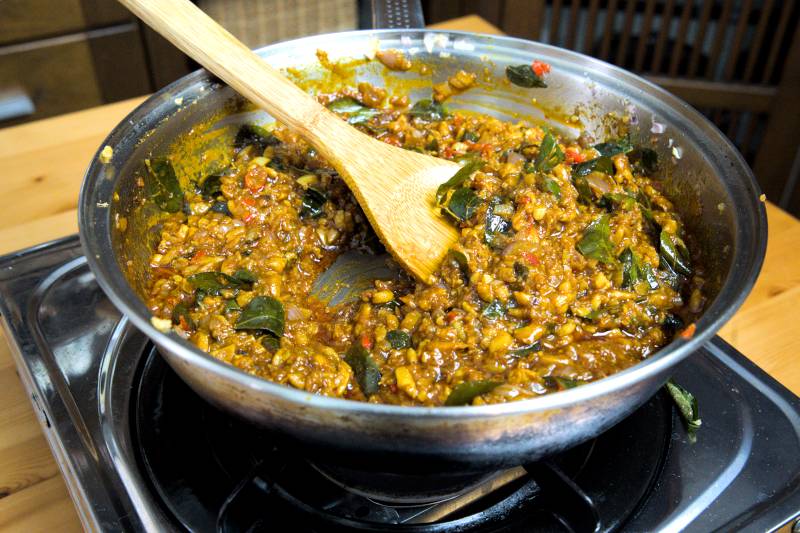 Continue cooking until most of the water has evaporated and the mixture thickens. The kam heong sauce is ready