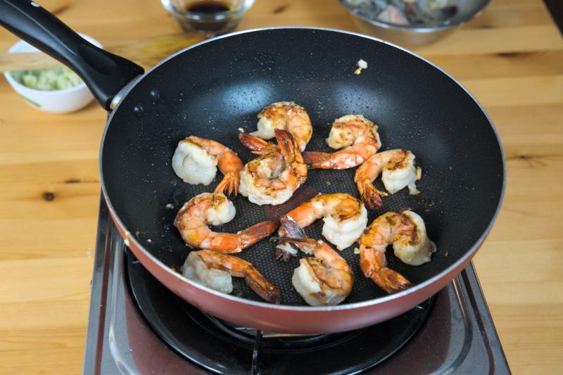 Sear both sides until juicy shrimp with char marks appear.