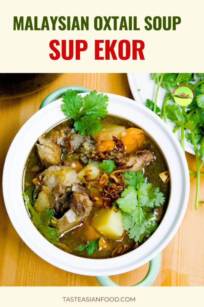 Malaysian Sup Ekor oxtail soup served hot with clear broth, tender oxtail, carrots, potatoes, and garnished with fried shallots and coriander leaves